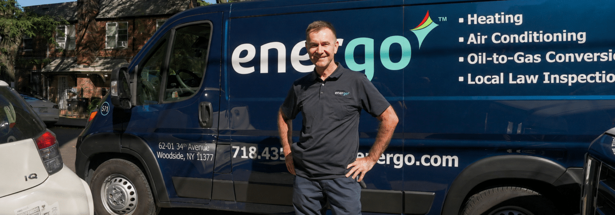 Energo service van parked on NYC street, technician standing nearby