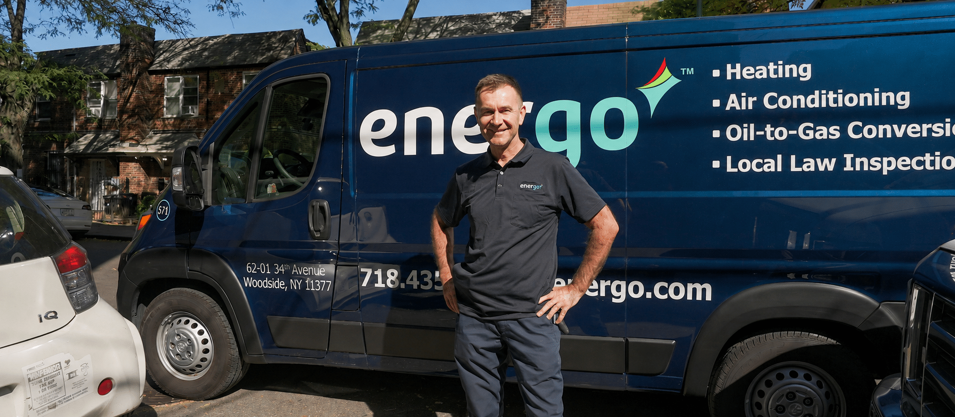 Energo service van parked on NYC street, technician standing nearby