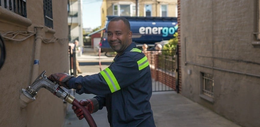 Energo employee wearing gloves with hose over shoulder