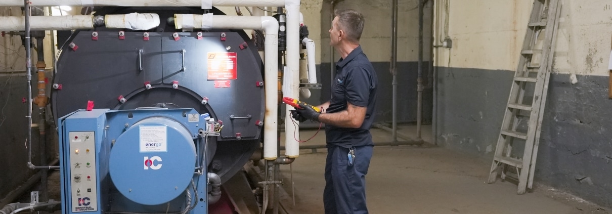 Energo service technician performing boiler safety checks