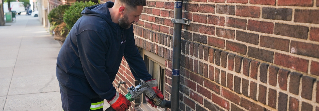 Energo technician connecting heating oil delivery line