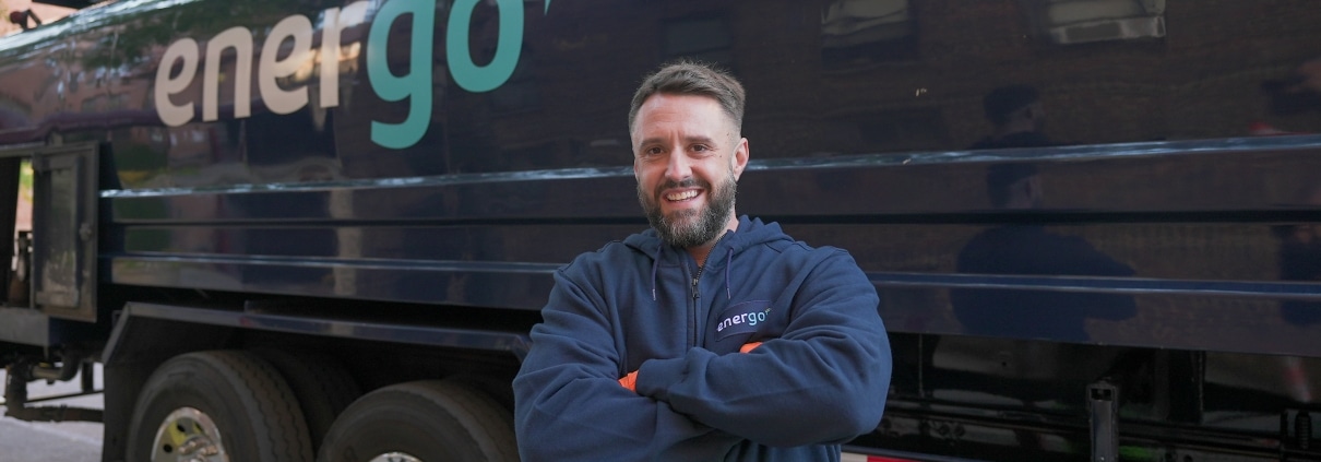 Energo technician posing with heating oil delivery truck in New York