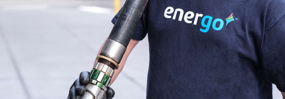 Energo employee wearing gloves with hose over shoulder