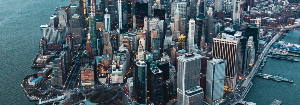 Aerial view of Manhattan at sunset with skyscrapers and harbor
