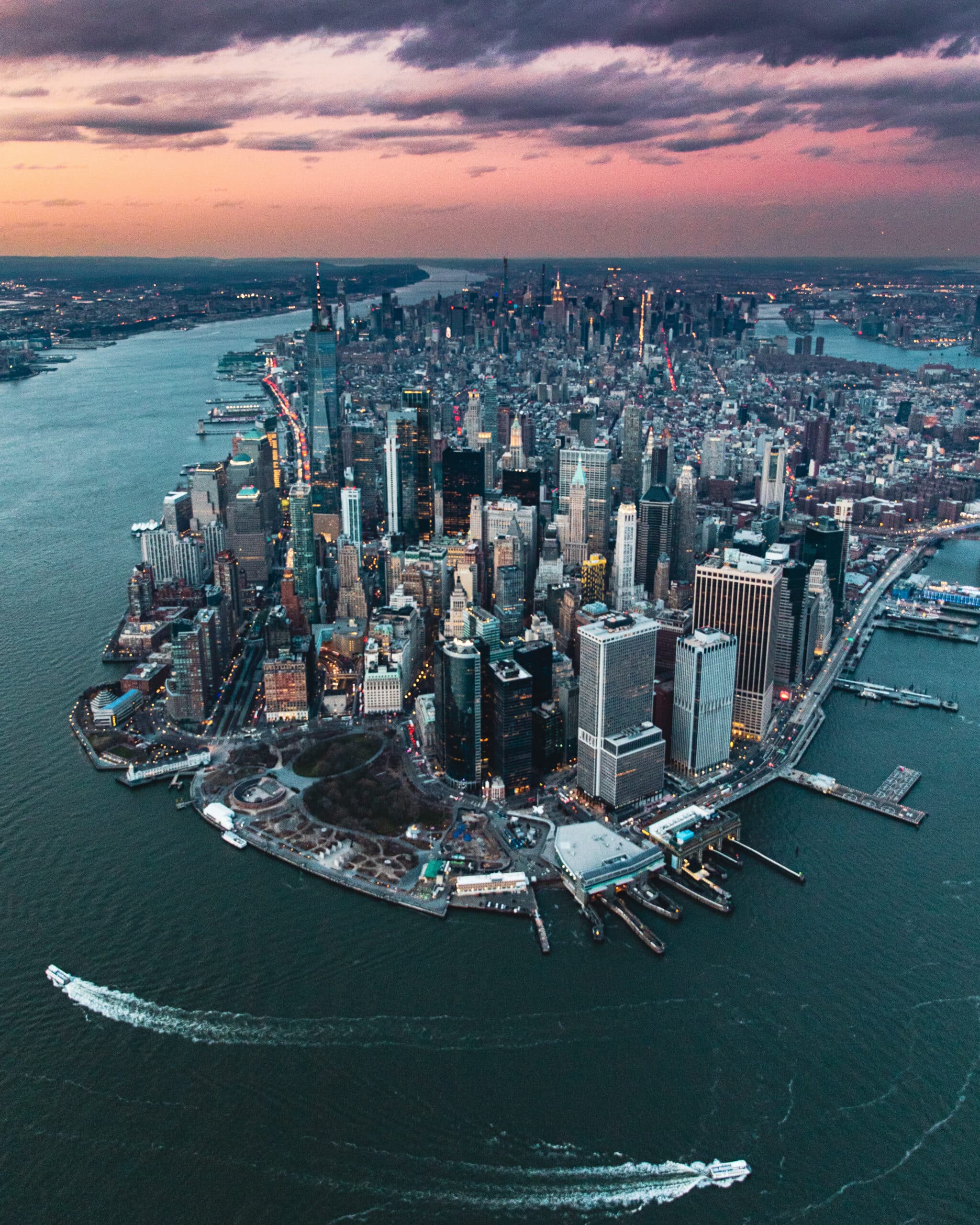 Aerial view of Manhattan at sunset with skyscrapers and harbor