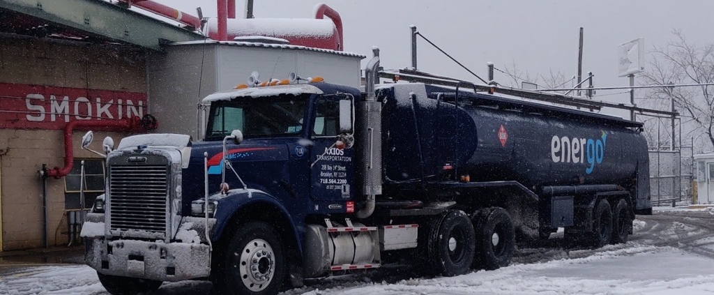Energo heating oil delivery truck driving through snowstorm