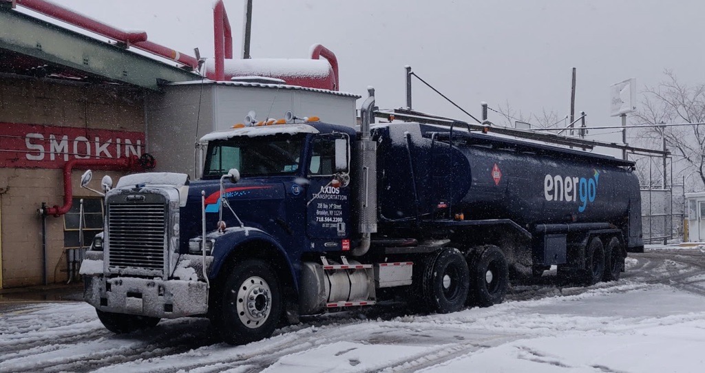 Energo heating oil delivery truck driving through snowstorm