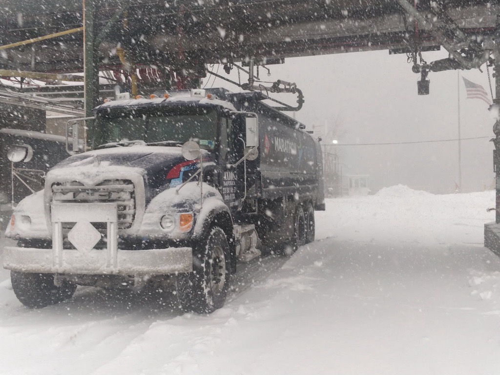 Energo heating oil truck driving through snowy weather conditions