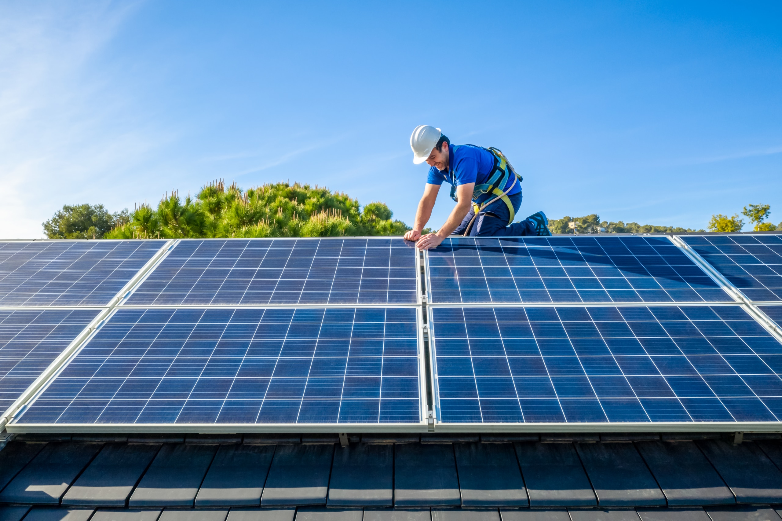 Technician working on rooftop solar panels