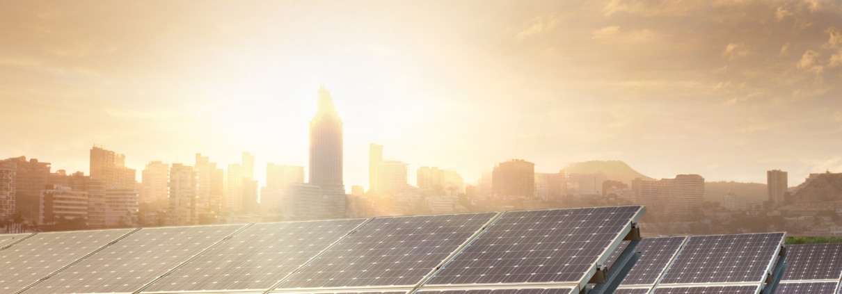 Solar panels with a city skyline in the background
