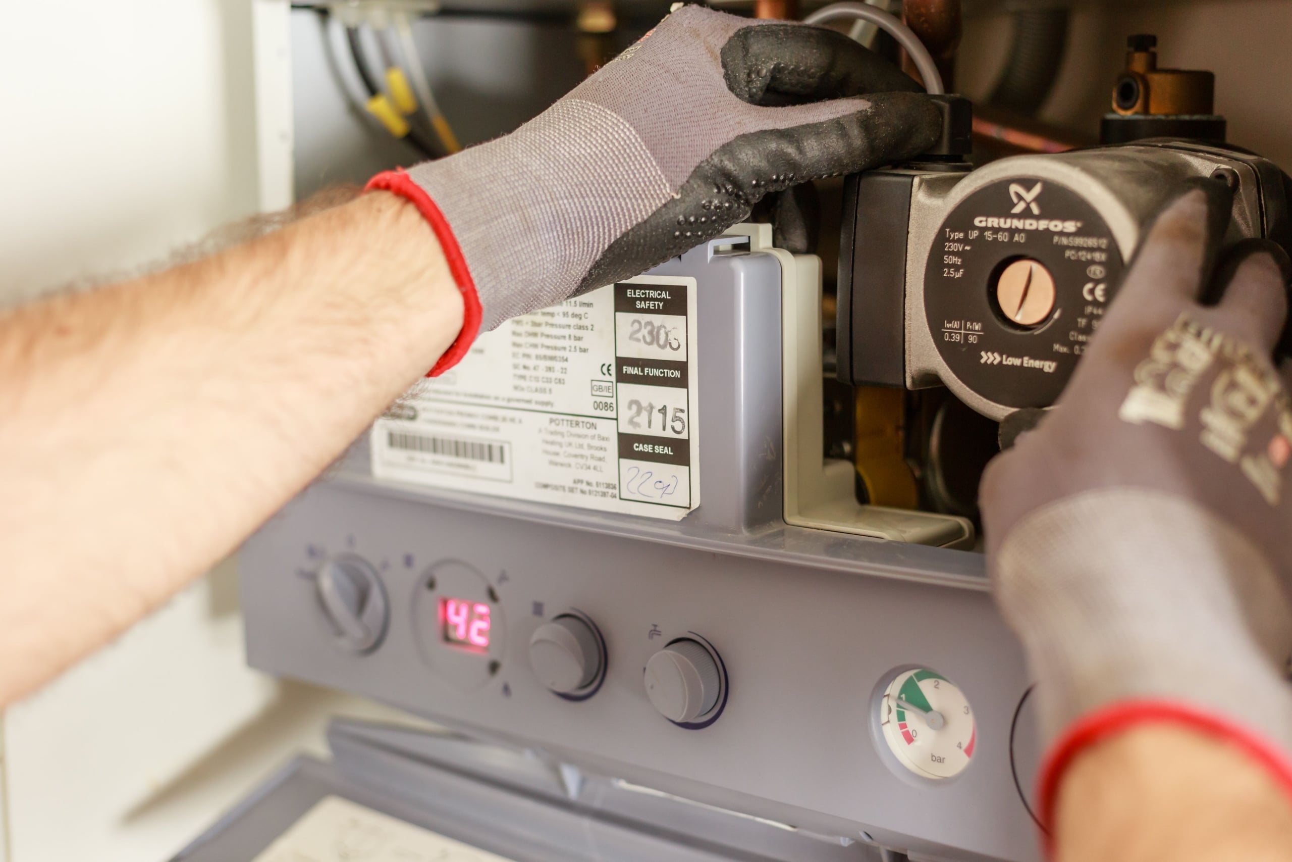 Technician servicing a boiler during routine maintenance and inspection