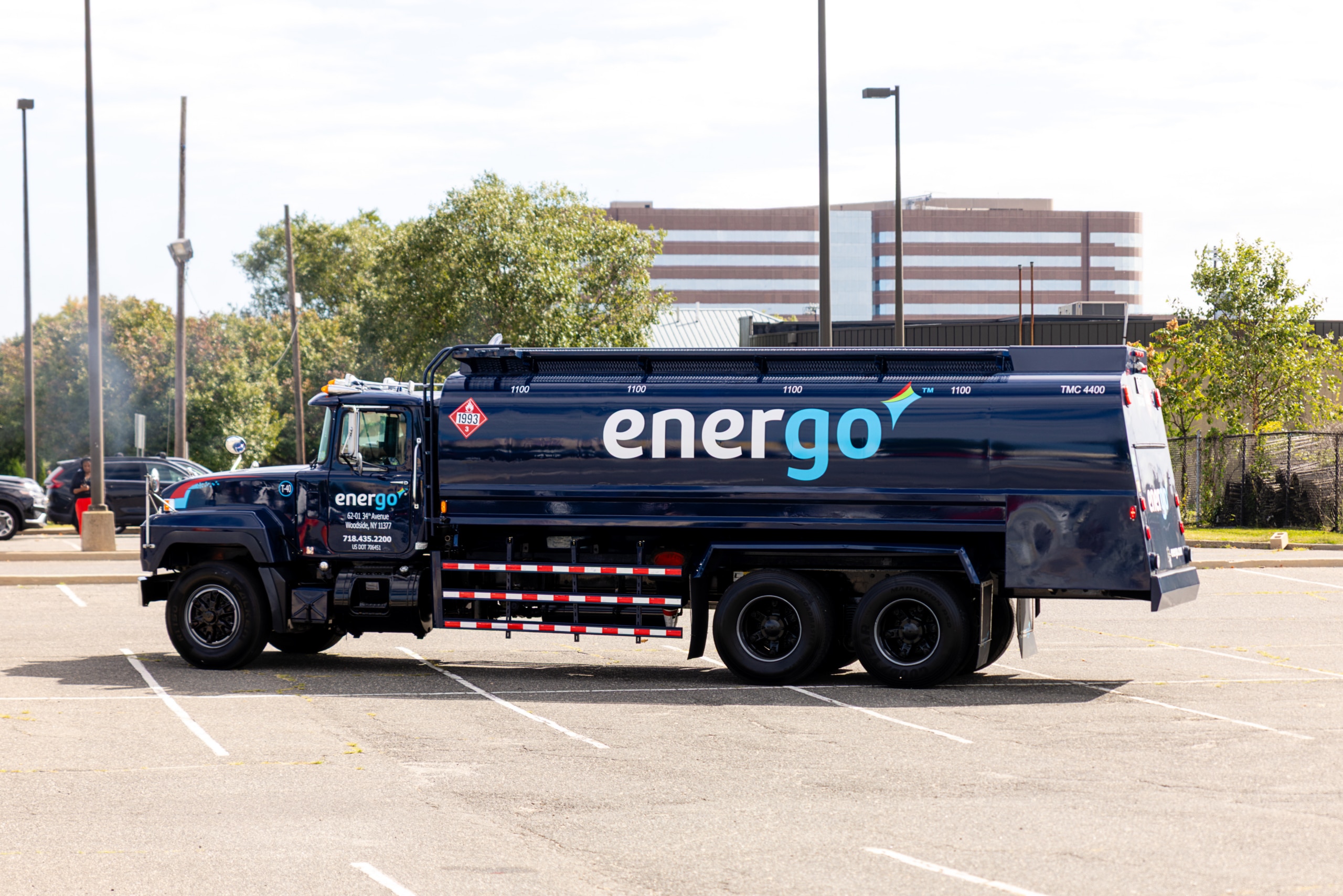 Side view of a large blue Energo fuel delivery tanker parked in a lot