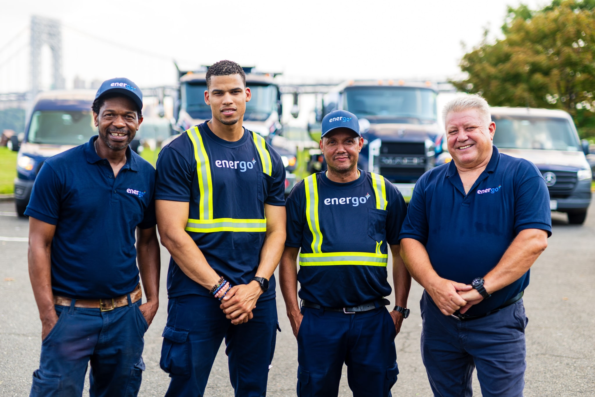 Four Energo employees standing together beside a branded fuel delivery truck